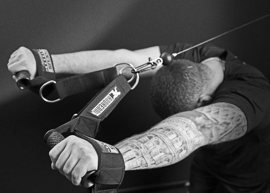 Lifter doing an overhead cable tricep extension with a rope on a functional trainer