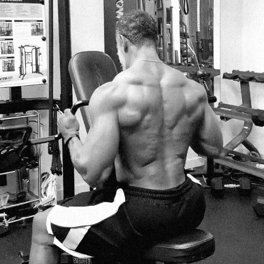 Muscular man doing a pulldown in garage home gym