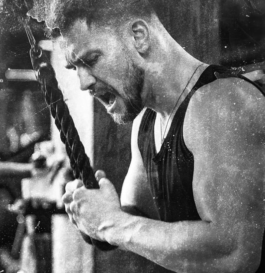 Man doing tricep pushdowns with regular ropes