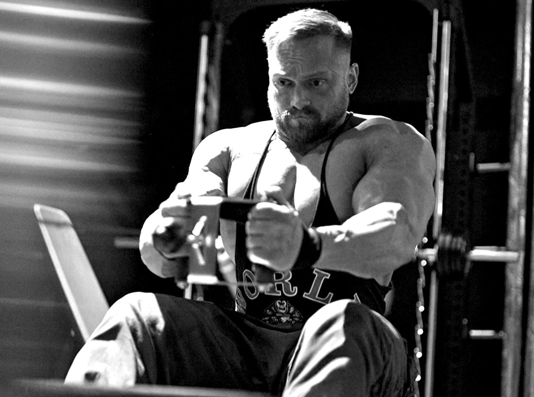 Man doing seated cable row in black and white picture