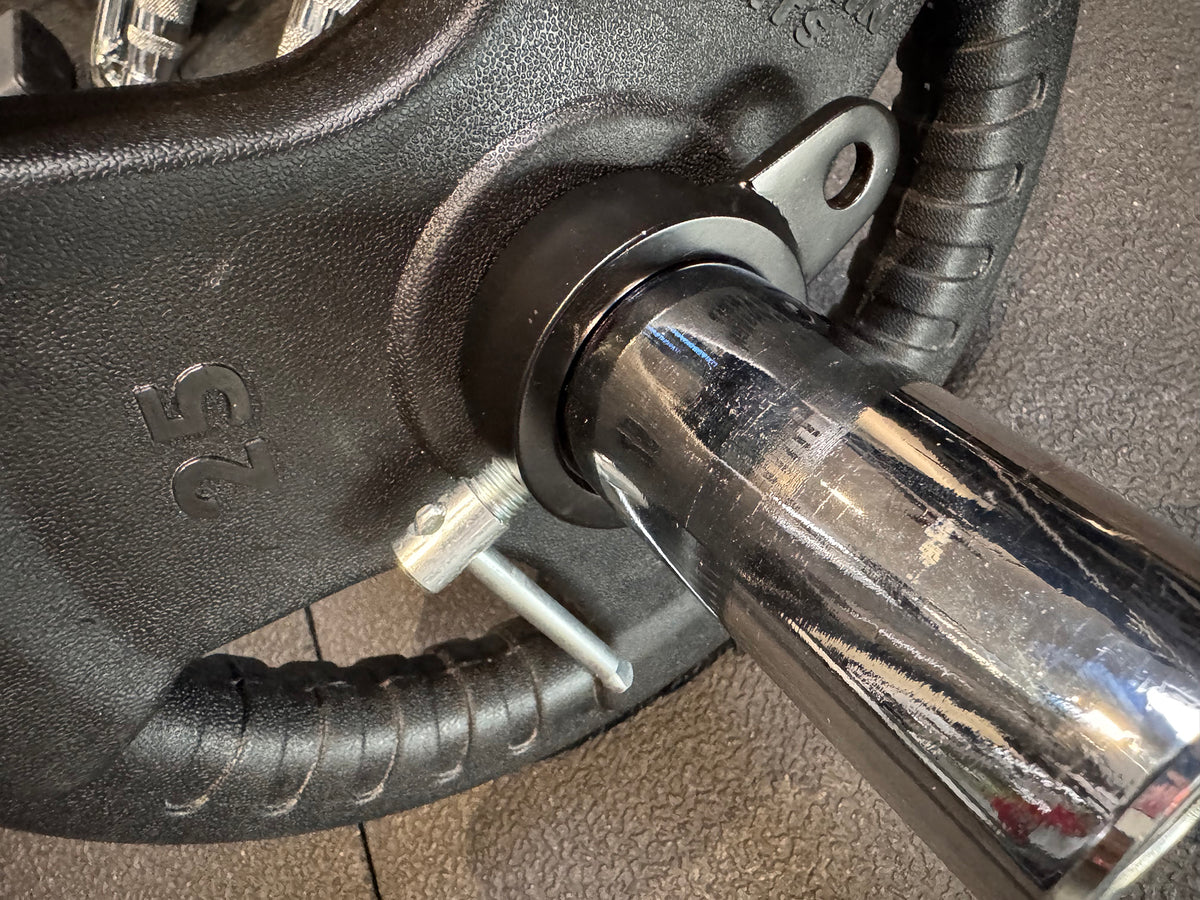 Andreoni cable barbell collars holding weight plates on a barbell