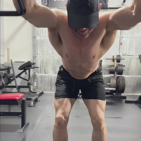 HGHR performing standing straight arms pulldowns with Andreoni bar