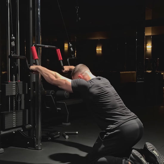 Straight-Arm Cable Pulldown (Lat prayer) exercise demonstration with the Andreoni bar on a cable machine in a dark home gym.