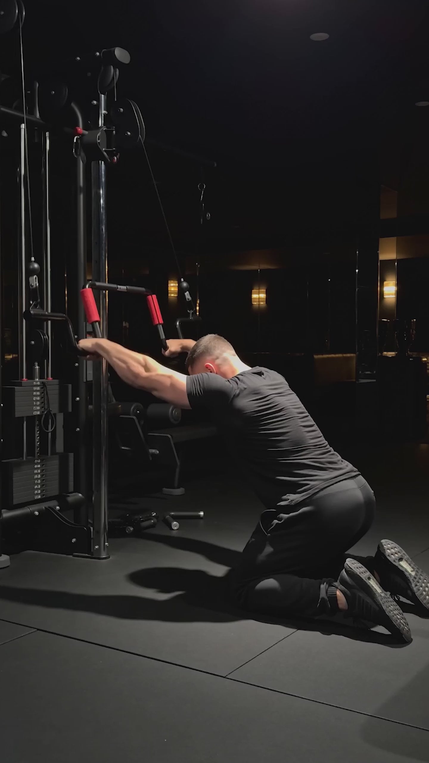 Straight-Arm Cable Pulldown (Lat prayer) exercise demonstration with the Andreoni bar on a cable machine in a dark home gym.